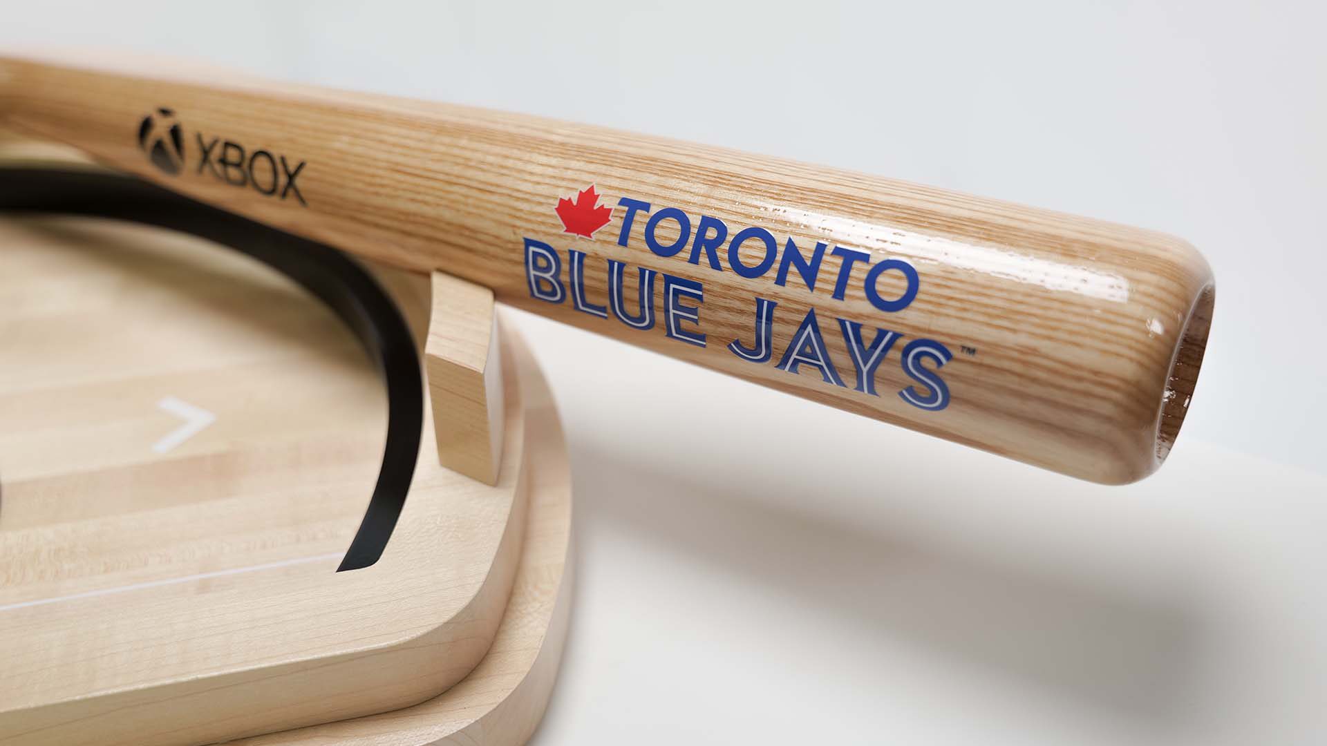 Xbox and Toronto Blue Jays wooden baseball bat resting on the stand