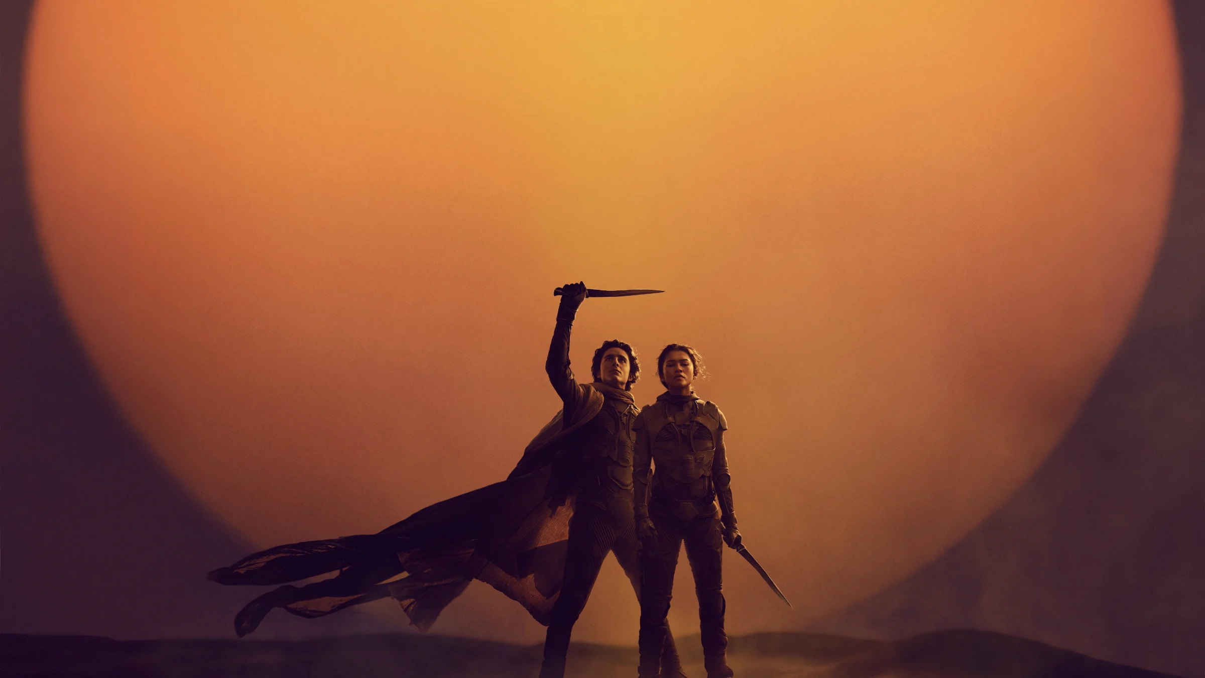 Dune: Part Two key art: Paul Atreides and Chani before a giant sun on Arrakis