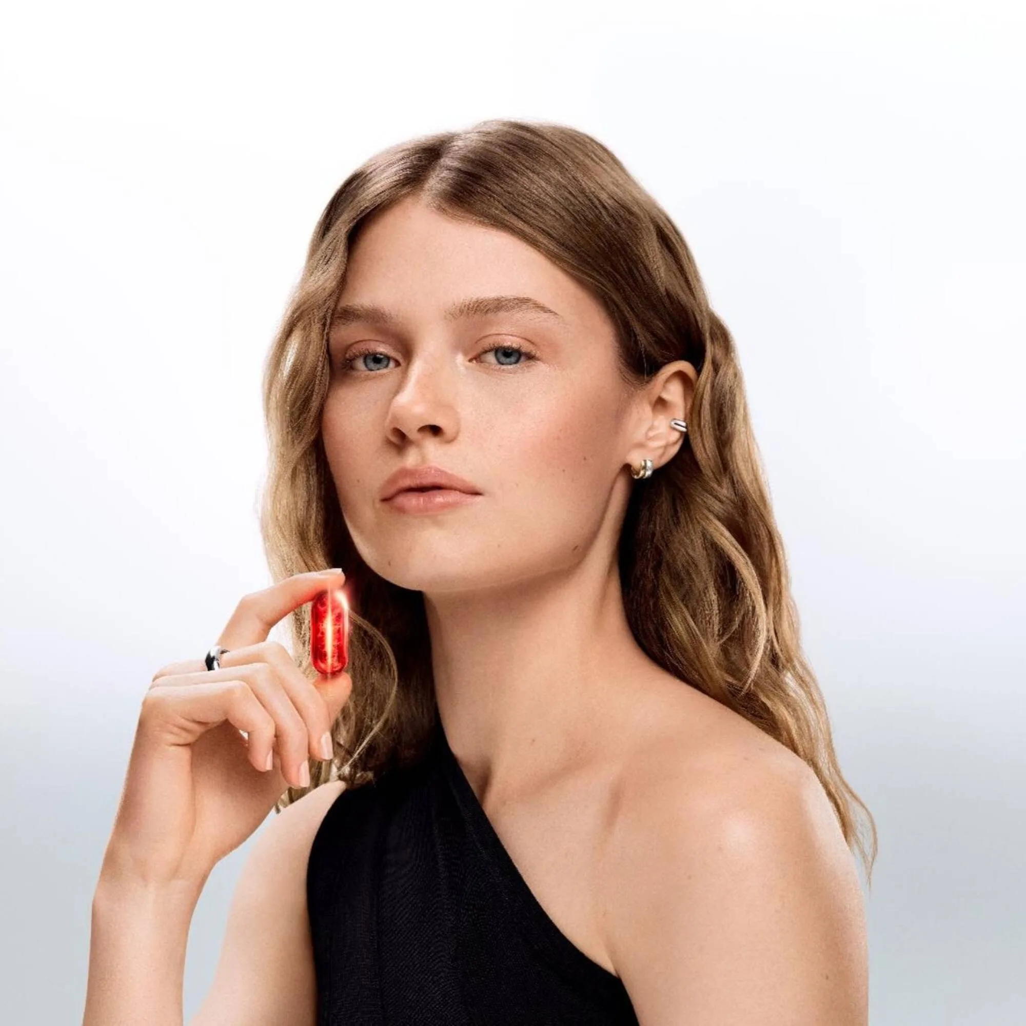 Model holding the red time-line capsule to the light