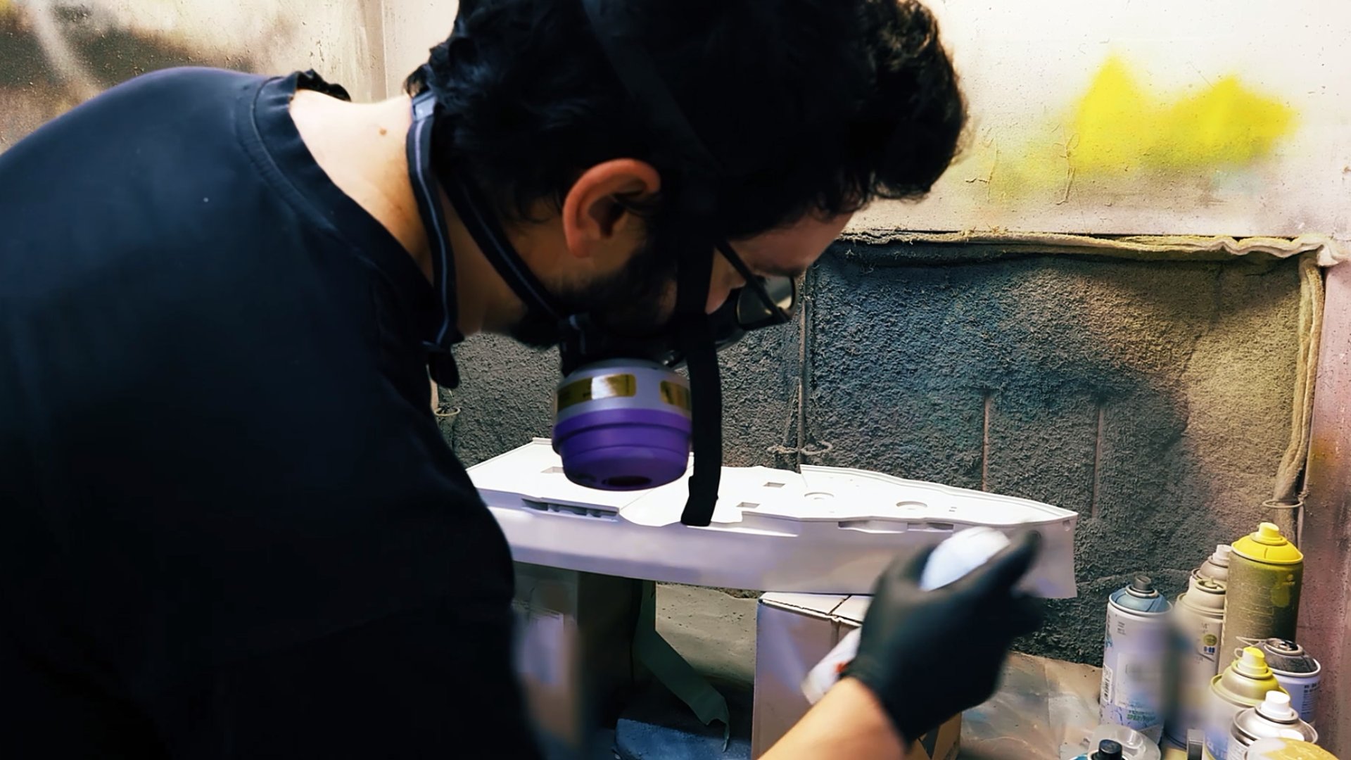 Spray-painting the battleship hull in the workshop